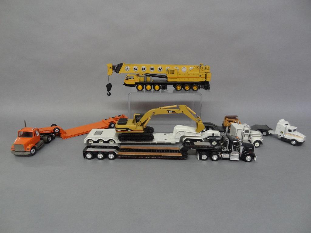 Die Cast Trucks and Crane: N20 Modelle crane, Silky flatbed tractor trailer w/cat 325BL, Franklin rep. flatbed tractor trailer Kenworth, Conco flatbed tractor trailer Freightliners, Ertl flatbed tractor trailer Kenworth w/skid 