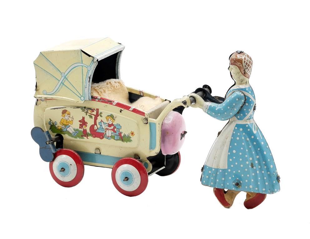 Haji Lady Pushing Stroller Wind-Up Toy: Vintage Japanese tin litho by Haji, lady pushing a stroller has spinning wood feet and ringing bell, 6.25"H