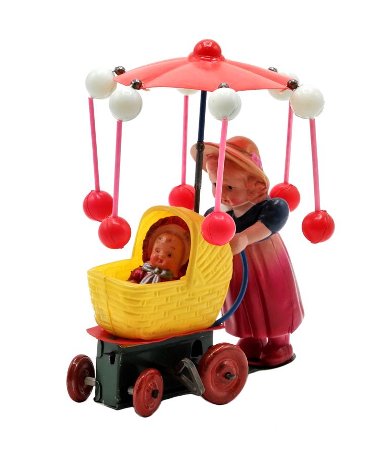 Vintage Japanese Win-Up Celluloid Toy: Vintage Japanese celluloid and tin wind-up toy, young girl pushing a baby in a stroller with spinning umbrella, 6"H