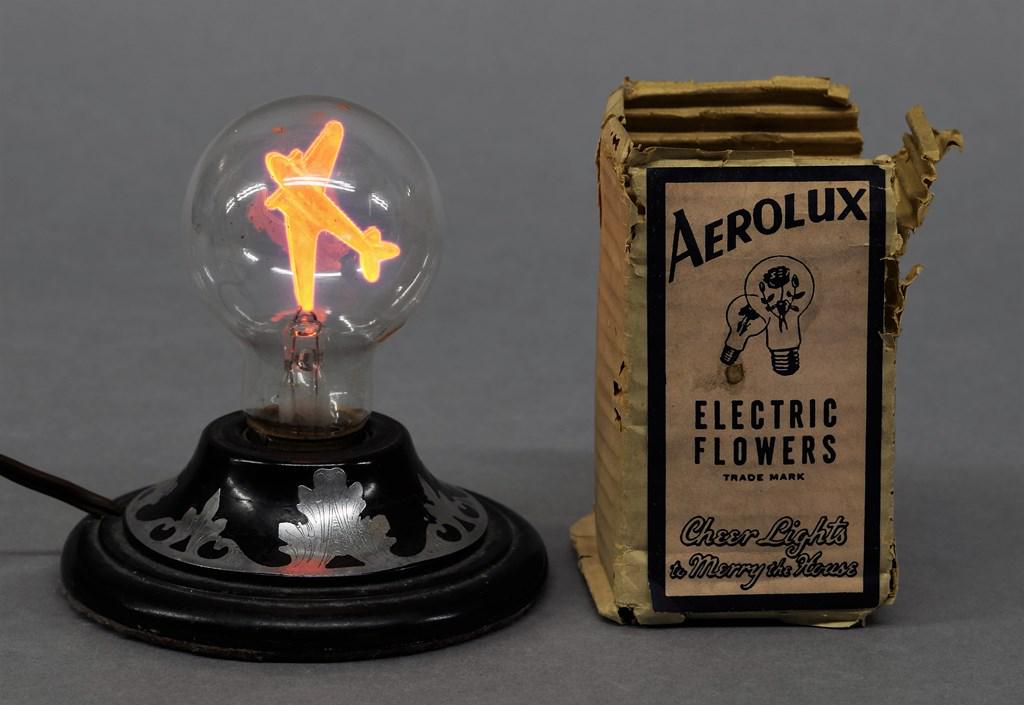 Vintage Aerolux Airplane Bulb: Vintage Aerolux electric bulb with metal airplane on top of filament, includes original packaging, 4"H, lamp not included