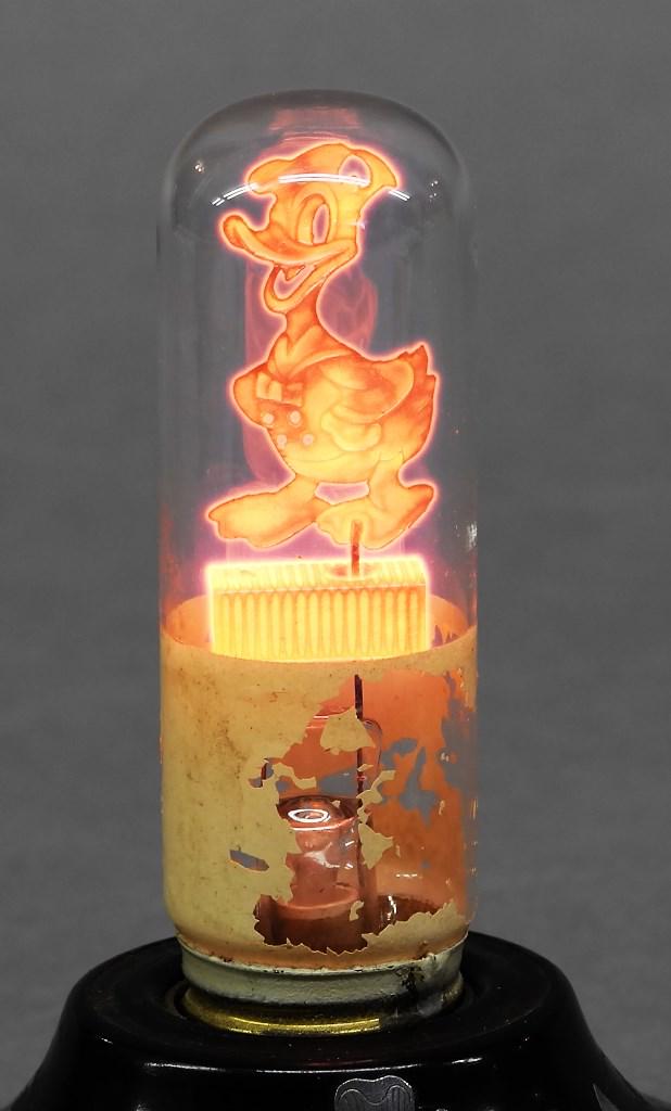 Aerolux Donald Duck & Scotty Dog Bulbs: Vintage Aerolux electric bulb with metal Donald Duck on top of filament and worn painted Donald Duck around base with original packaging 4.25"H, Scotty dog bulb with original packaging 3.75"H, lamp no