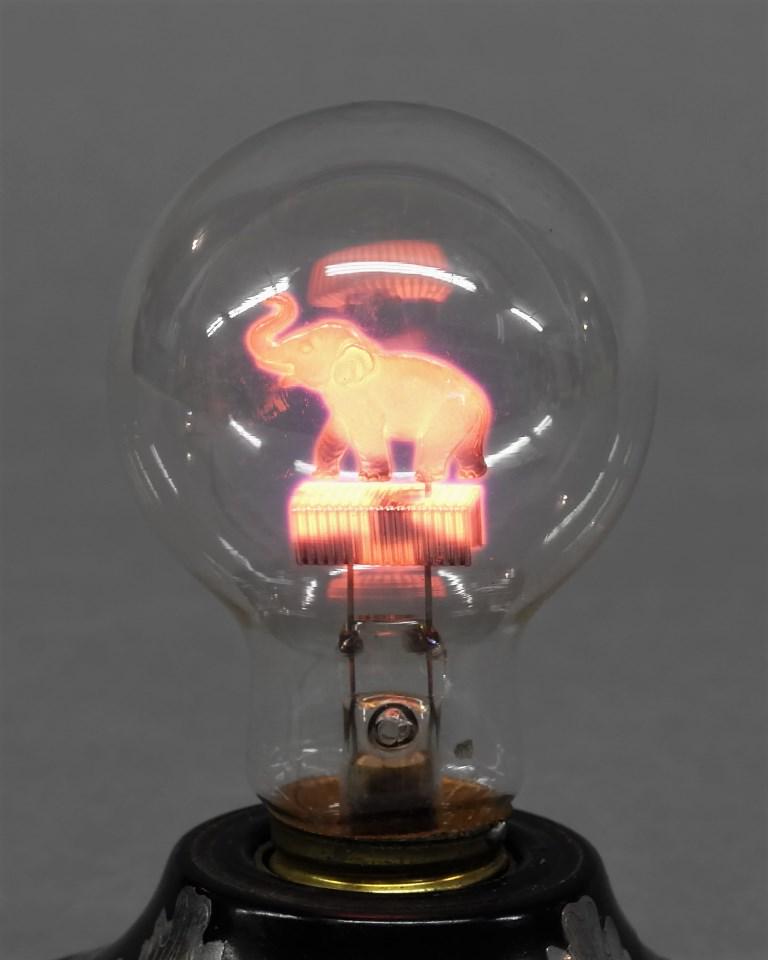 Vintage Aerolux Elephant Bulb: Vintage Aerolux electric bulb with metal elephant on top of filament, 4"H, lamp not included