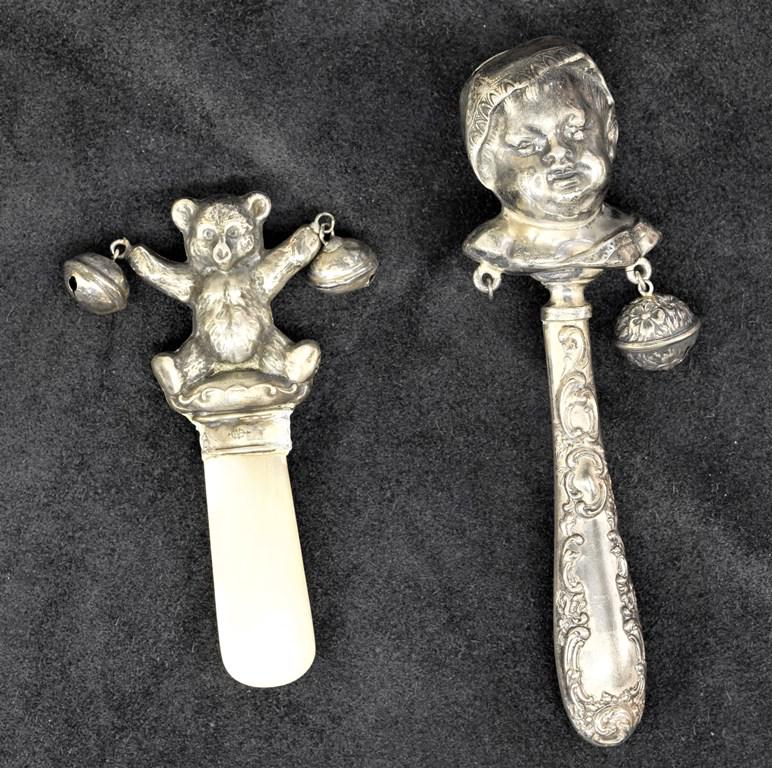 Two Sterling Figural Baby Rattles: Vintage Teddy Bear baby rattle with mother of pearl nip marked Sterling with hallmark for Webster Company 3 7/8"L, Baby head wearing a bonnet rattle double stamped "STER" 5.5"L