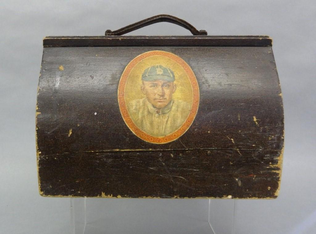 Ty Cobb Portrait Child's Sports Box: Antique child's wood sports equipment box in the shape of a doctor's bag, well made with a dovetailed case, leather strap with brass hardware, hinged door with iron lock and brass escutcheon, front ha