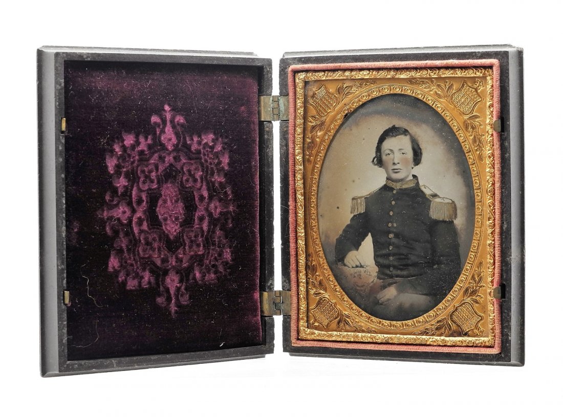 U.S. Military 1/6 Plate Ambrotype Photo: Original 1/6 plate Ambrotype of a young man wearing a tunic; collar, epaulets and buttons are painted in gold on top of image, case is labeled Littlefield, Parsons & Co. Manufacturers Of Daguerreotype