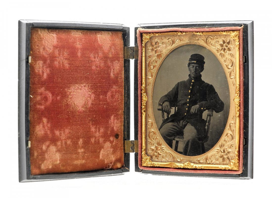 Civil War Soldier 1/4 Plate Ferrotype Photo: Original 1/4 plate tintype or ferrotype of a young man in Union uniform, wearing kepi and 9 button coat sitting in a Windsor chair, gutta percha case depicts the capture of Major Andre during The Revo