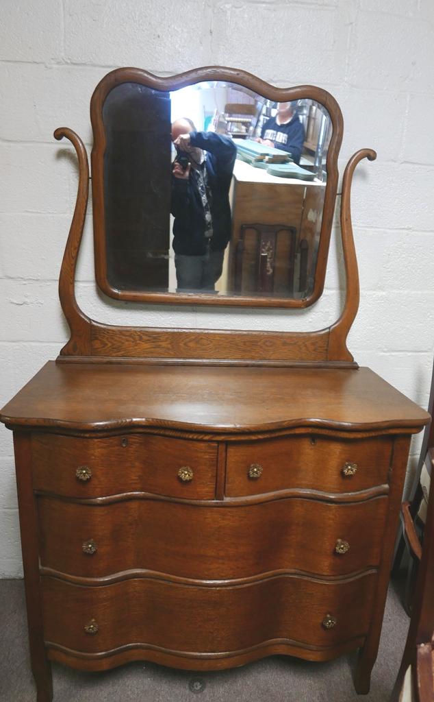 Victorian Oak Dresser With Mirror: Antique oak dresser with scalloped front, two small drawers over two full width drawers with original brass pulls and locks, case has paneled sides, includes original beveled glass mirror and frame, 4