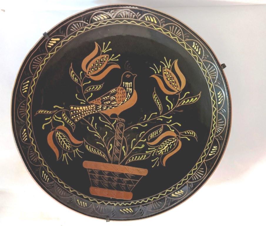 Lester Breininger 22" Redware Charger: Lester Breininger huge 22" redware charger with poly chrome slip decoration, bird perched on a basket with sgraffito decoration holding four tulips, signed on reverse and dated 1995, includes a hand w