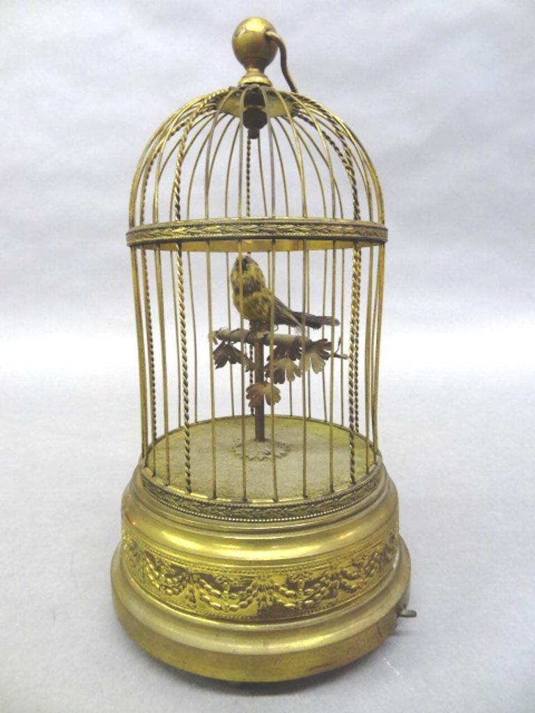 Antique French Automaton Bird In Cage: Antique French wind-up with chirping and animated bird, signed on bottom "B. Altman & Co. Made In France", 11.5"H to top of finial