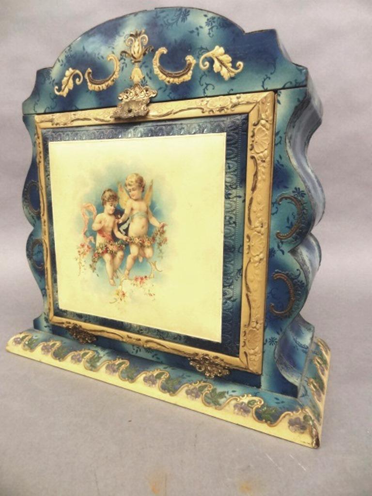 1920's Ladies Celluloid Dresser Set: Lady's rococo style celluloid dresser box with fitted interior, front opens when top is lifted, interior includes beveled mirror, two glass perfume bottles, two turned bone cosmetics containers, compo