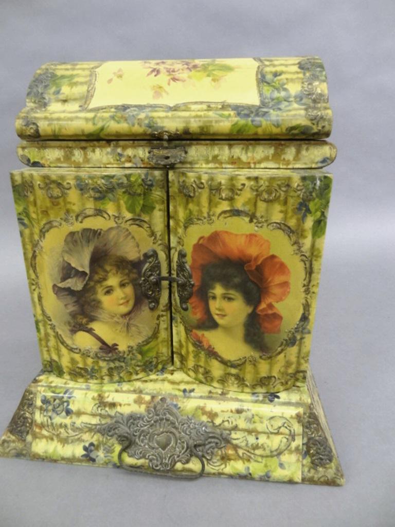 1920's Ladies Celluloid Dresser Set: Lady's celluloid covered fitted dresser box, hinged lid with beveled mirror covers compartment retaining two cosmetic jar, main body has two hinged doors with mirrors over a single drawer with brass h
