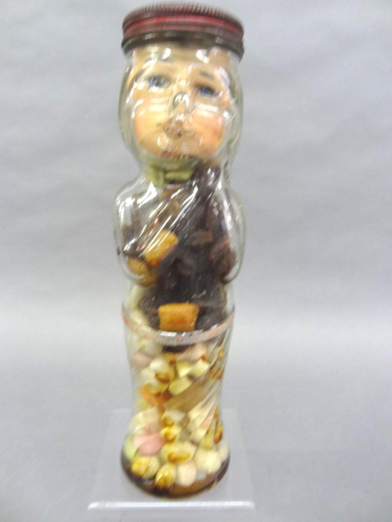 Figural Glass Boy Candy Container: Large pressed glass figural candy container with tin lid and paper face, paper belt around waist advertises Brandle Smith Co. Phila..... Pa., 10.75"H
