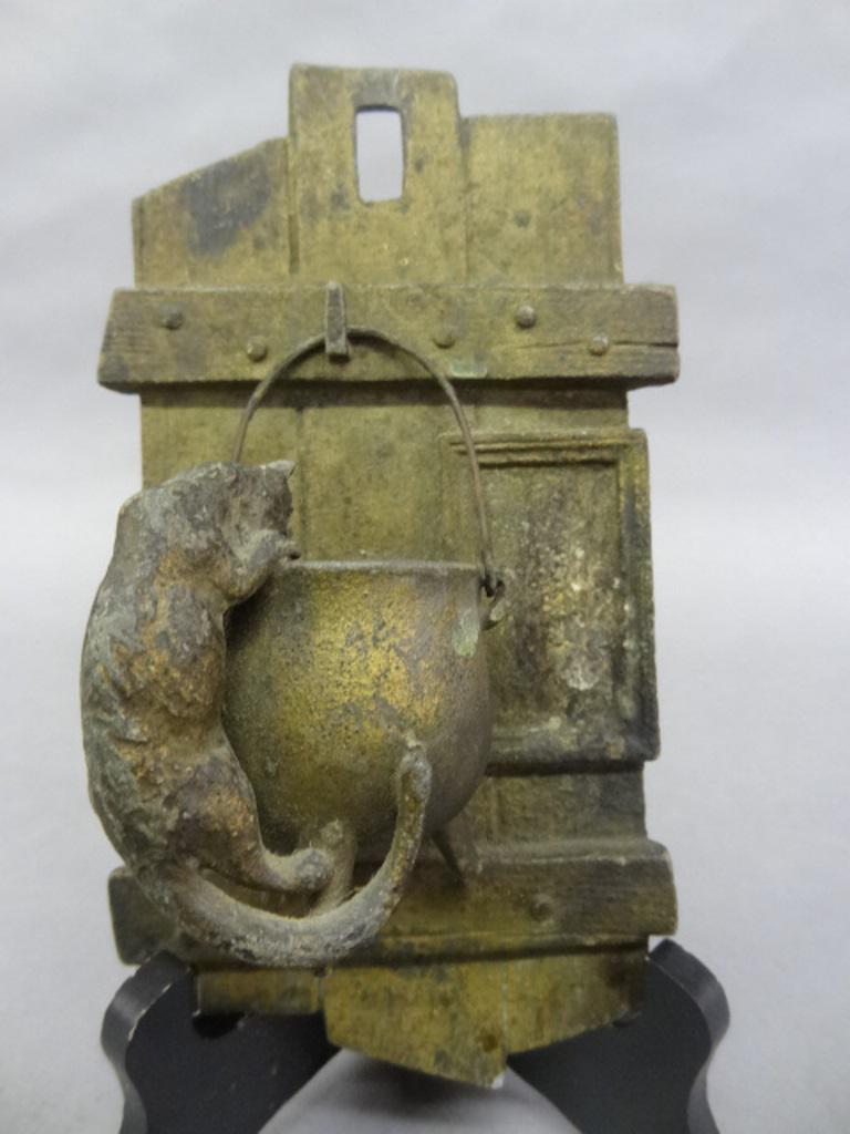 Figural Cat & Kettle Match Holder/Safe: Figural cast metal hanging match holder depicting a cat climbing into a kettle hanging on a fence gate, late 1800's, 8"H, 4.25"W