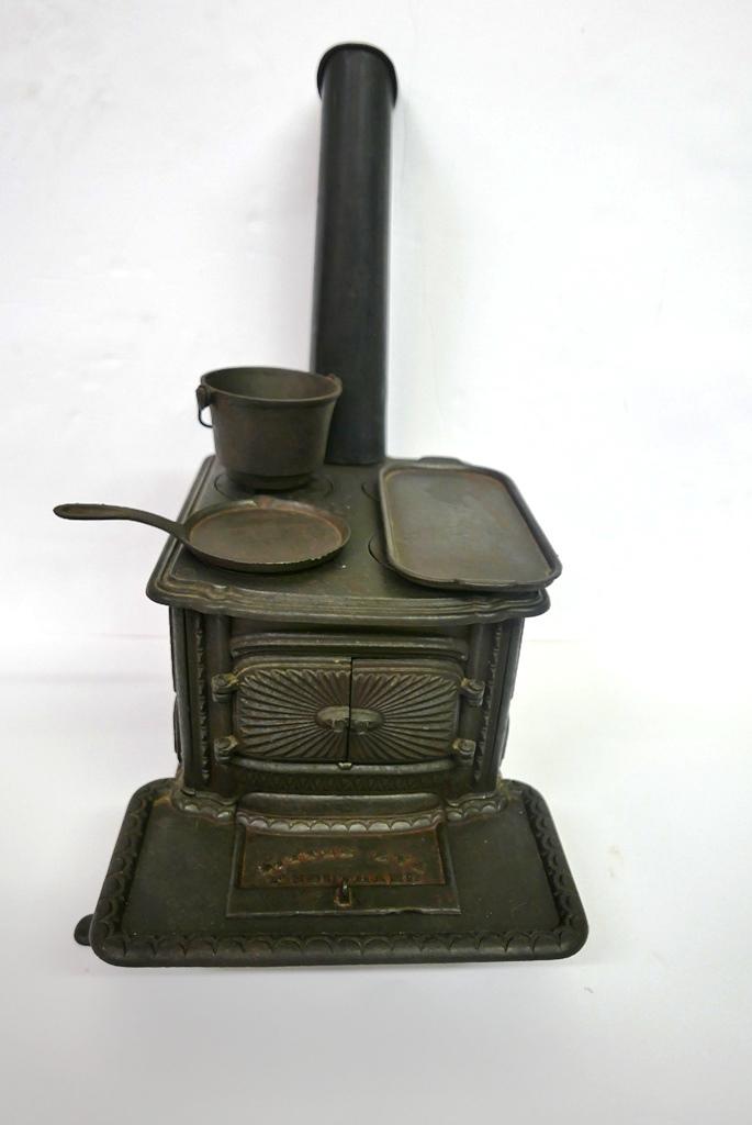 T. Southard "Little Eva" Toy Stove: Very ornate cast iron child's toy stove by T. Southard, opening doors on front and sides with nicely detailed interior, includes cast iron broiling pan and skillet, sheet metal chimney, 13.5"L, 12.5"W