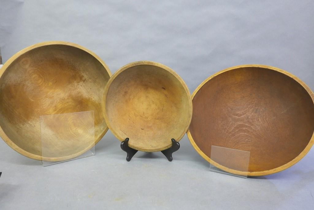 Three Large Painted Turned Wood Bowls: Three milk painted artisan turned bowls appear to be made by the same hand, yellow bowl 14" by 15.25" by 4"H, blue painted bowl 14" by 15" by 4"H", black painted bowl 10.5" by 11.25" by 2.5"H