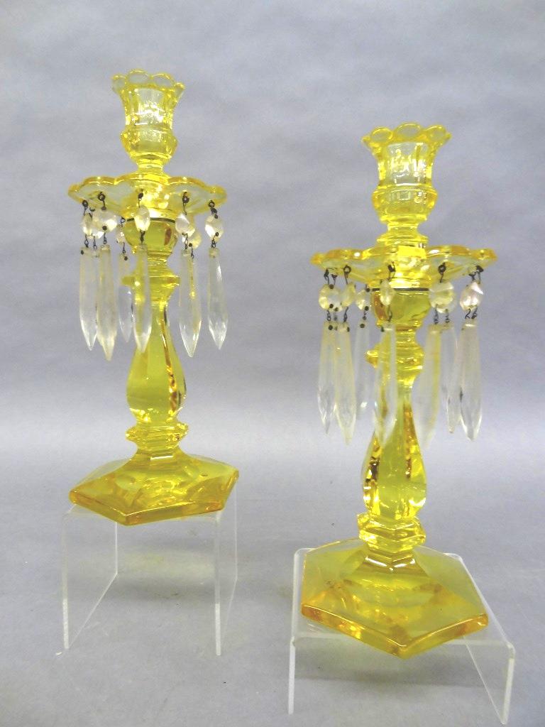 Pair Of Heisey Sahara Yellow Candlesticks: Pair of vintage Heisey glass candlesticks in Sahara Yellow, scalloped bobeche with ten hanging prisms on a hexagon base, 11.5"H