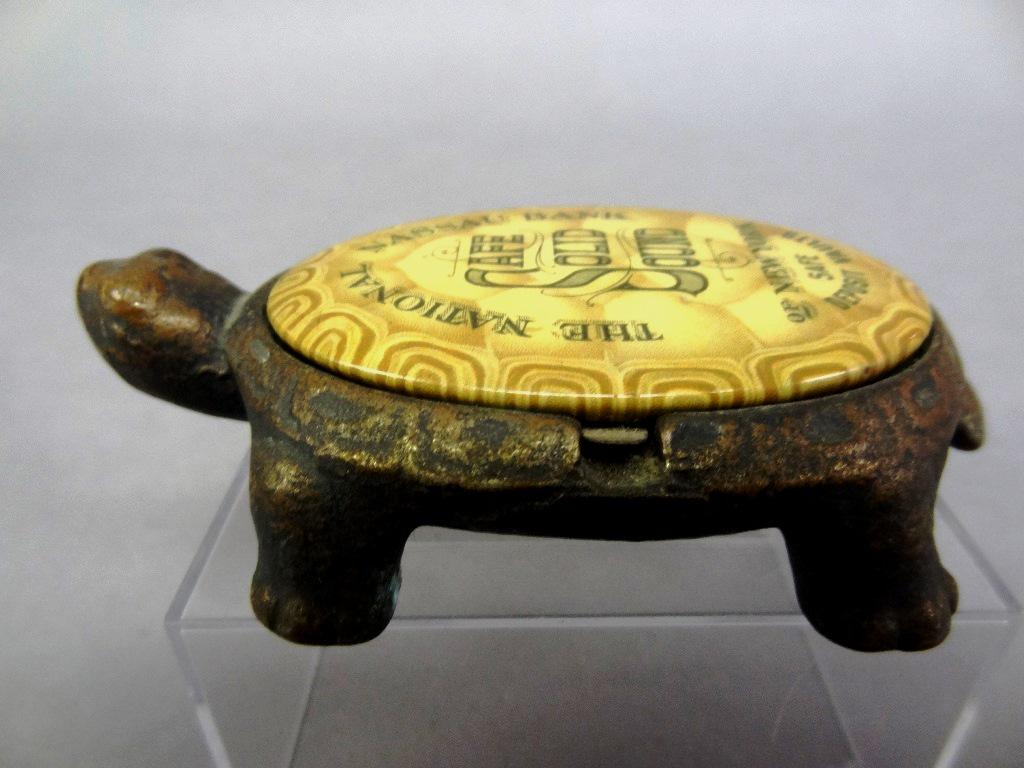 Antique Cast Iron & Celluloid Advertising Compact: Antique cast iron turtle compact with traces of brass plating, hinged lid is a celluloid mirror advertising "The National Nassau Bank Of New York Safe Deposit Vaults Safe Solid Sound", 4 1/8"L, 1 3/8"