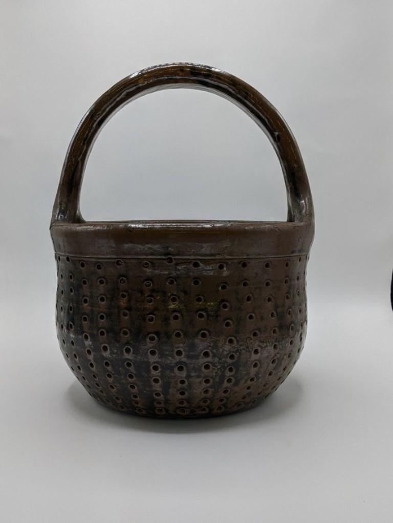 Redware Cheese Strainer: Redware cheese strainer, brown glaze with touches of manganese, 12"H, 9.5"W