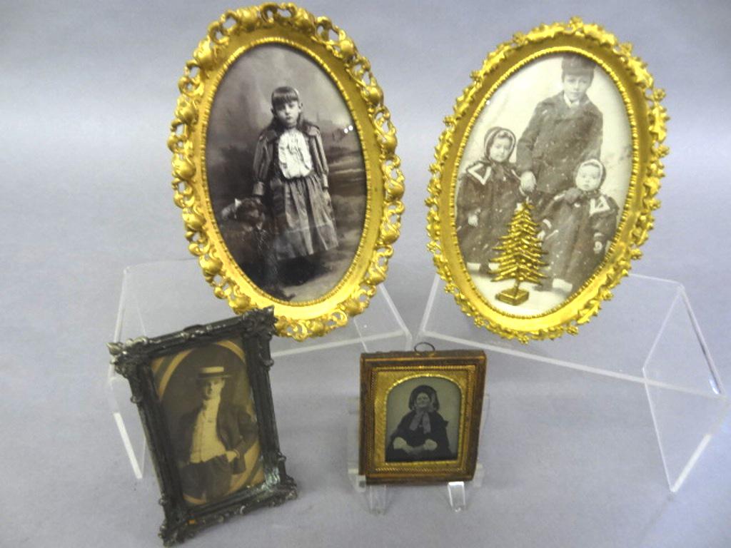 Group Of Early Photographs: Early photo of a young girl standing next to her dog, housed in a gilt brass easel back frame 4.5" by 6.6", early photo of three children mounted with an ormolu Christmas tree in a gilt brass easel ba
