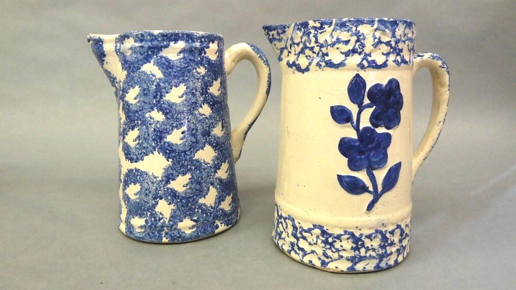 Two Blue Sponge ware Pitchers: Antique stoneware pitcher with raised blue flower and blue sponge decoration 9"H, antique stoneware pitcher with blue sponge trellis decoration 9"H