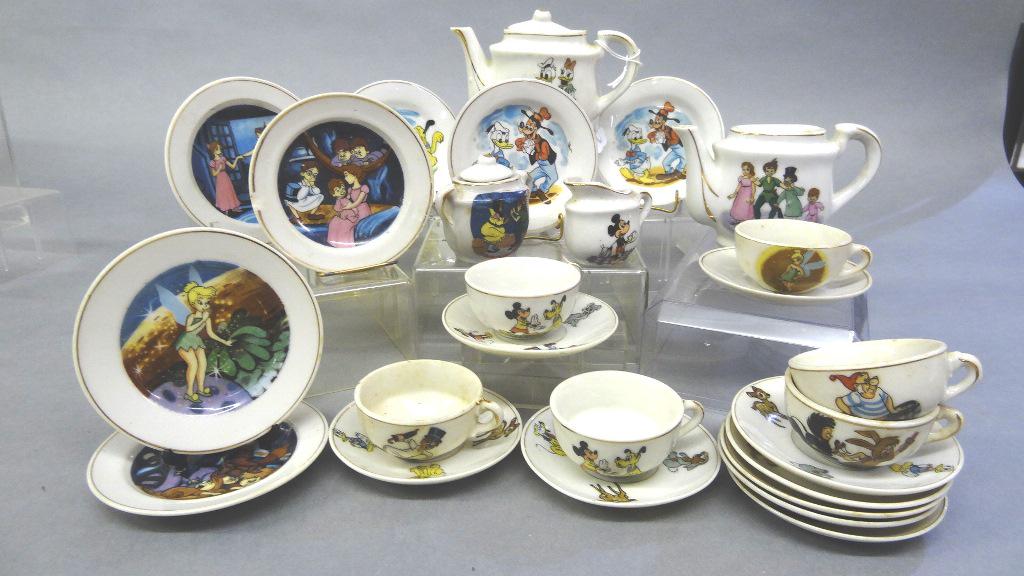 Two Marx Child's Disney Tea Sets: Two vintage partial sets, Vintage Marx Disney child's china tea set includes teapot 5.5"W, creamer, two cups, four saucers and three plates, Marx Peter Pan set includes teapot lacking lid, sugar bowl,