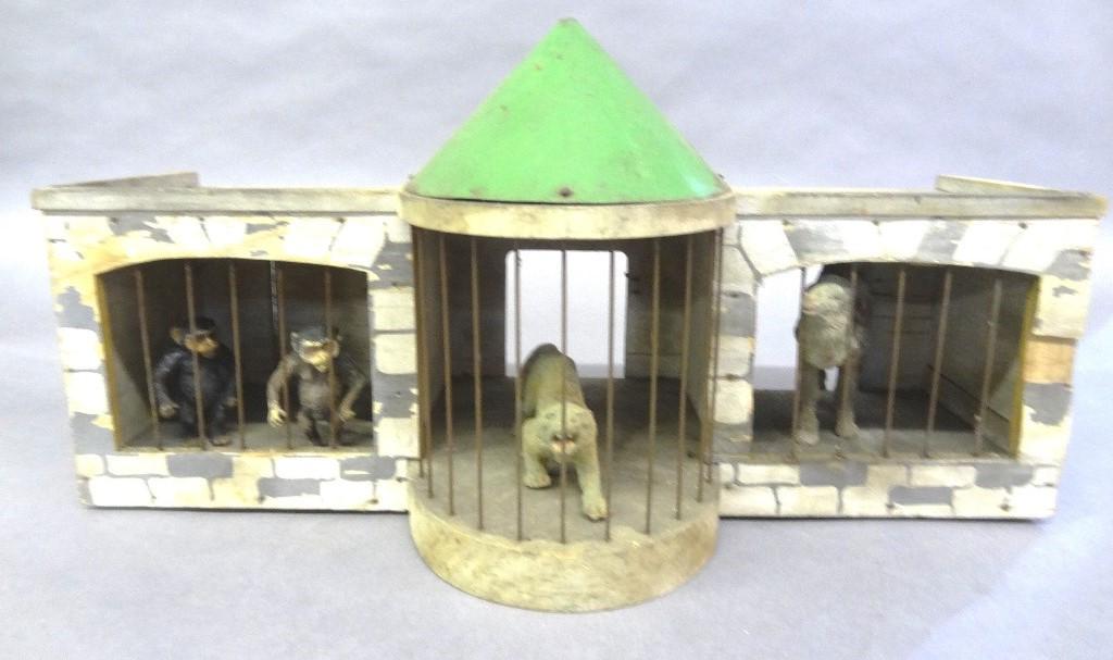 Antique German Toy Zoo: Antique German painted wood zoo with tin dome and wire bars, 18.75"W, 9.25"H, 8"D,comes with four animals, camel, two monkeys and a tiger with age cracks