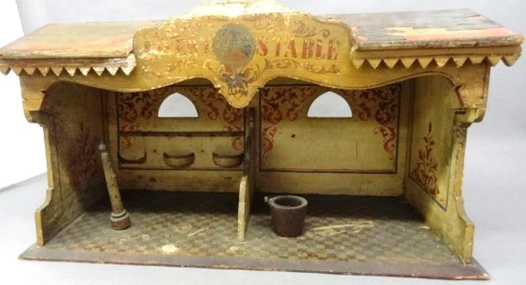 Antique Toy Livery Stable: Antique toy wood Livery Stable, litho paper covered roof, pin striped sides, painted checkerboard floor, stencil painted front "Livery Stable" sign with a horse head in a round medallion, stencil deco