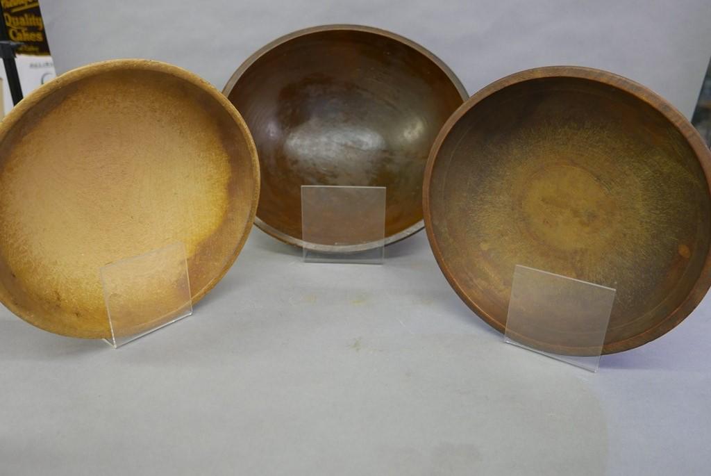 Three Large Turned Wood Bowls: Large wood bowl with brown stain 17" by 17 5/8" by 5.5"H, medium bowl 12" by 12 5/8" by 3"H, medium bowl with heavily worn interior 12" by 13" by 3.75"H