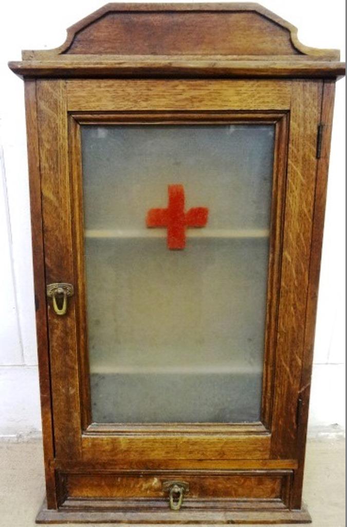 `Antique Oak Medicine Cabinet: Early 20th century oak hanging medicine cabinet, clear frosted door with painted red cross covering three shelves, single drawer in base, 29"H, 17"W, 6"D