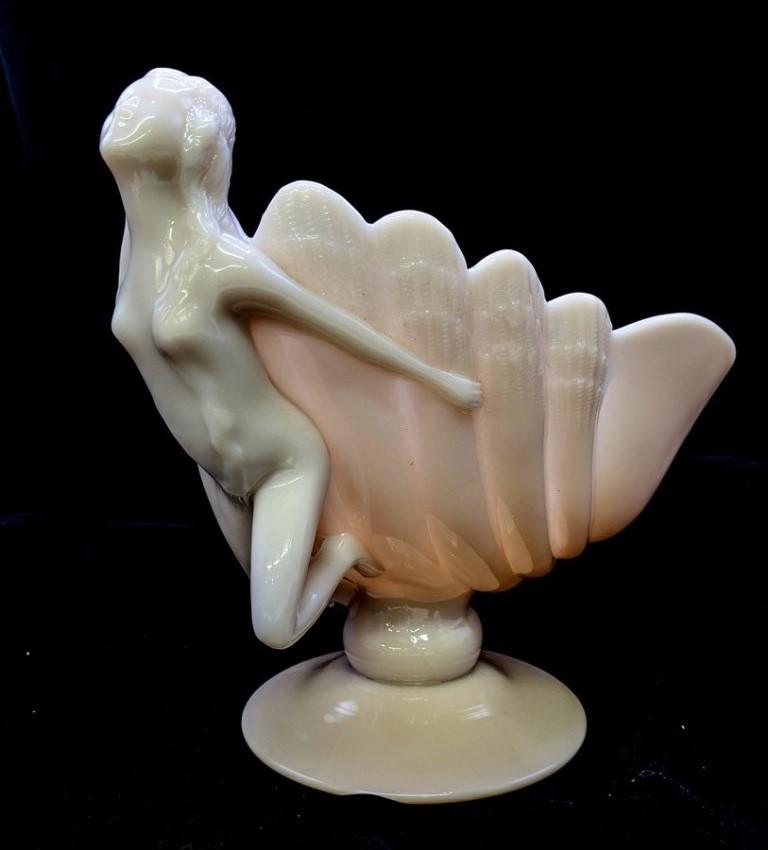 Cambridge Glass Figural Nude Compote: Cambridge pink glass shell form compote on a raised circular base has a full body nude on side, 9"H