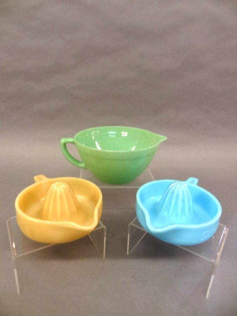 Sunkist Juicers & Fire-King Bowl: Two vintage opaque Sunkist glass juicers in caramel and turquoise 8.5"L, Fire-King green glass bowl with spout and handle 9.5"L
