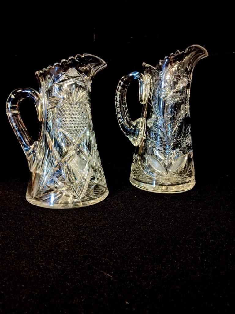 Two Cut Glass Pitchers, Heart & Butterflies: Two heavy cut glass antique pitchers, heart pattern 10"H, pitcher with flowers and butterflies 11.5"H