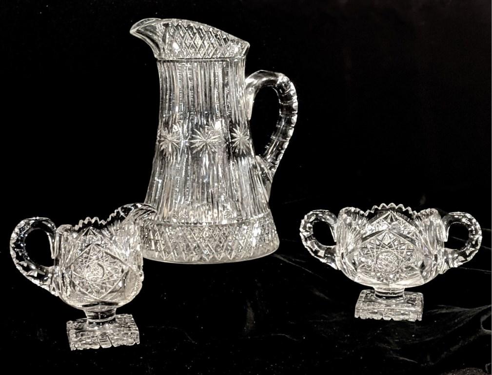 Cut Glass Pitcher, Sugar & Creamer: Antique cut glass matching creamer 5"H and sugar bowl 7"W both with a square foot, also a star pattern cut glass pitcher 10"H