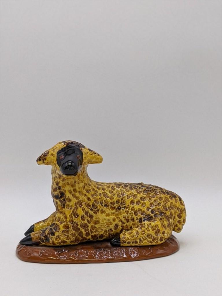 Lester Breininger Figural Sheep: Lester Breininger redware recumbent sheep with slip over punch and stamp decoration, dated 1999, 6.5"L