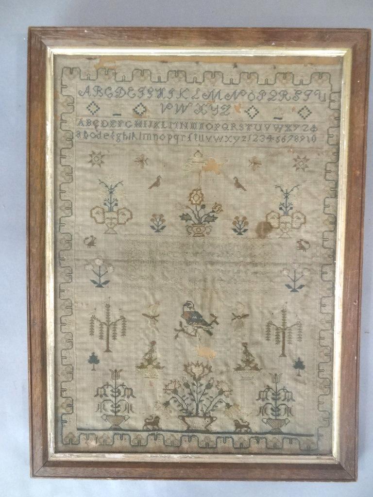 Early 19th Century School Girl Sampler: Original school girl sampler circa 1830's, decorated with alphabet, partly readable quote from "Now in the heat of youthful blood" by Isaac Watts, plants in pots, birds on branches, lions etc., sight 