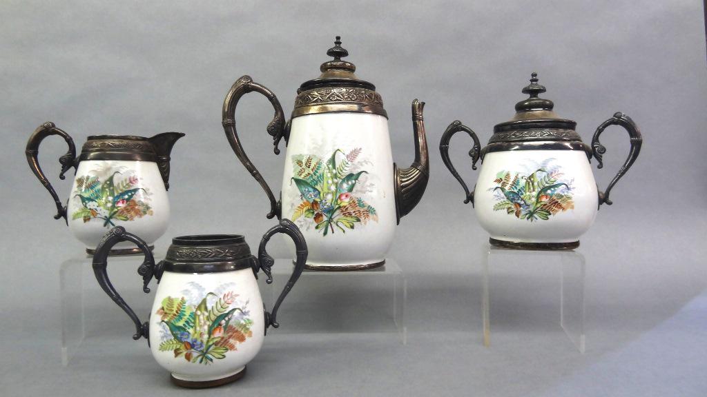 `Manning Bowman Fern Enamelware Tea Set: Antique Manning Bowman four piece tea set, enamelware with hand painted fern decoration and silver-plate mounts, coffee pot 10.5"H, sugar bowl with lid, creamer and waste bowl