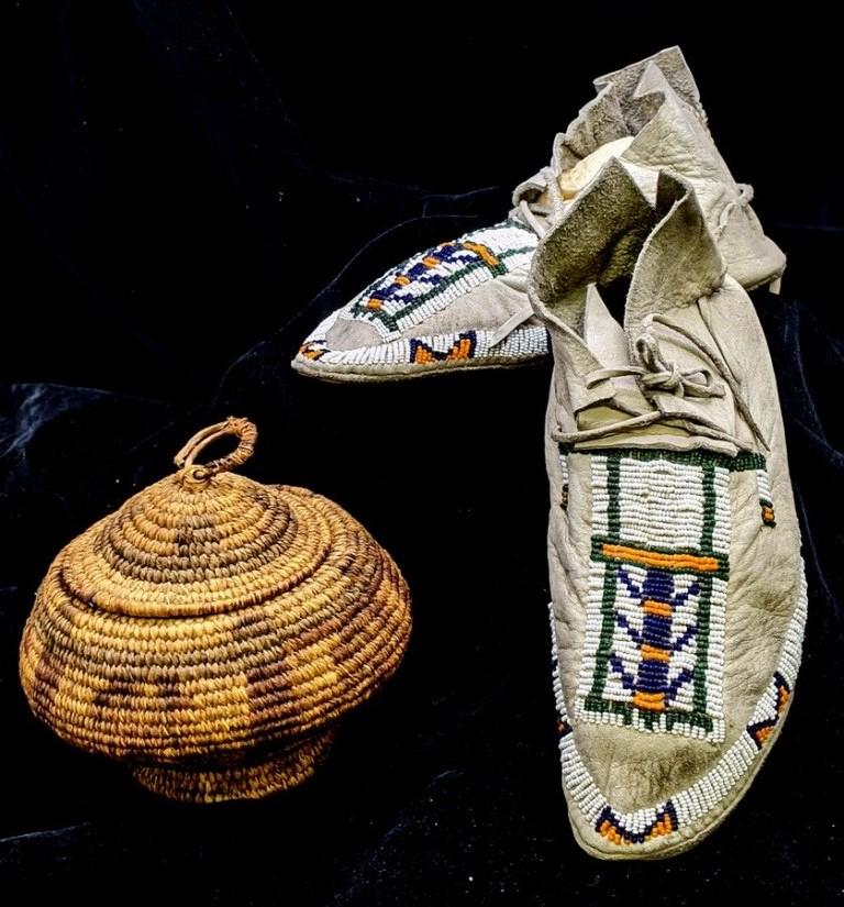 Vintage Native-American Beaded Moccasins: Pair of vintage bead decorated leather moccasins with soft leather soles 9.25"L, also includes a vintage hand made woven grass basket with faded geometric coloring 5.5"D