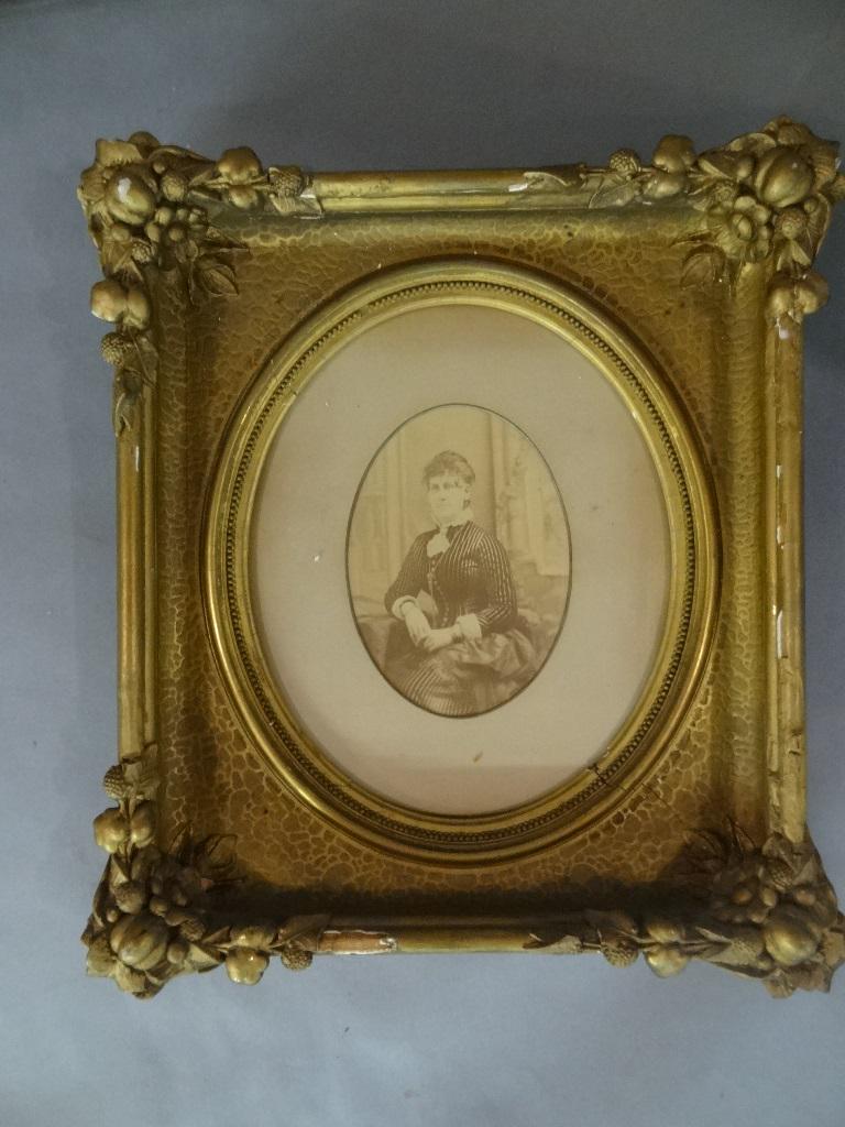 Two Large Framed Victorian Photographs: Large oval photograph of two young girls, image size 12.5" by 15.5", housed in an ornate gesso over wood frame 23" by 27", Victorian photograph of a beautifully dressed young lady, image size 5" by 7"
