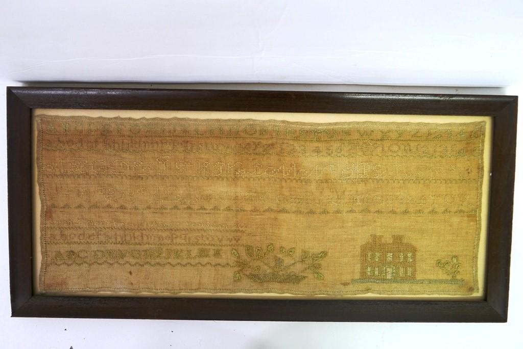 19th Century School Girl Sampler: Antique needlepoint school girl sampler featuring the alphabet in different fonts, basket of flowers and a manor house, signed illegibly, [Sarah Mary Lea??? Aged 9 years Jan 20], 8" by 21", remounted