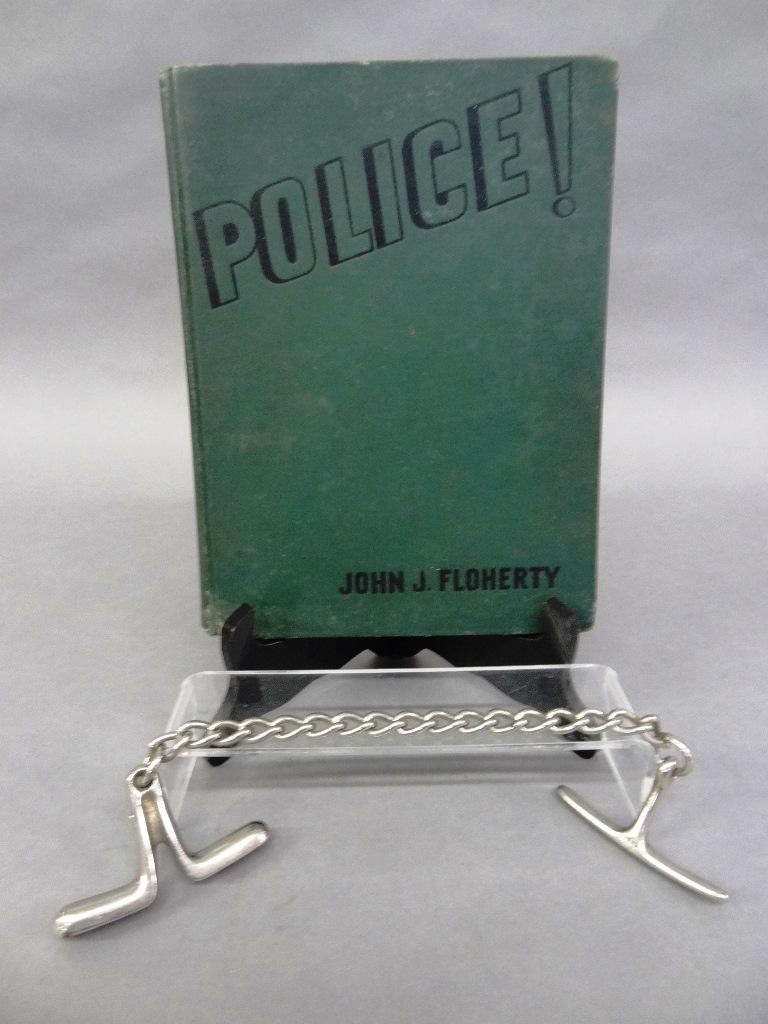 Police Wrist Restraint & Book: Early 20th century chrome plated policeman's wrist restraint marked Germany 13"L, Police by John J. Floherty 1936 illustrated book about policeman