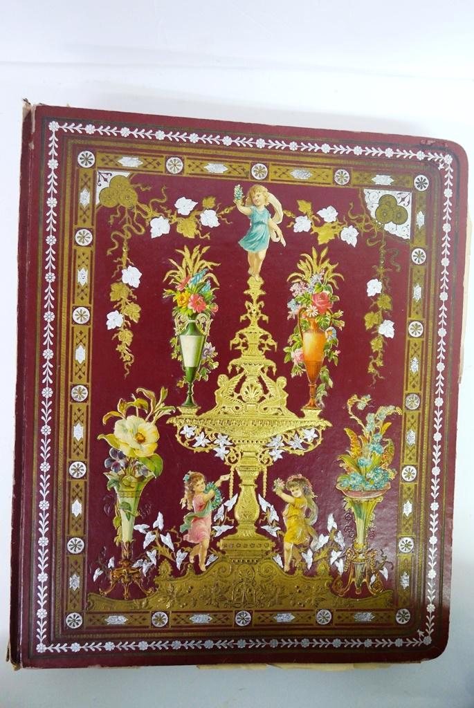 Fantastic Victorian Card Album: Ornate Victorian album, cover with silver and gold embossing and applied die-cuts 12.5" by 15", book is filled on 88 pages with trade cards, die-cuts, postcards, paper doll with hand made clothes and 