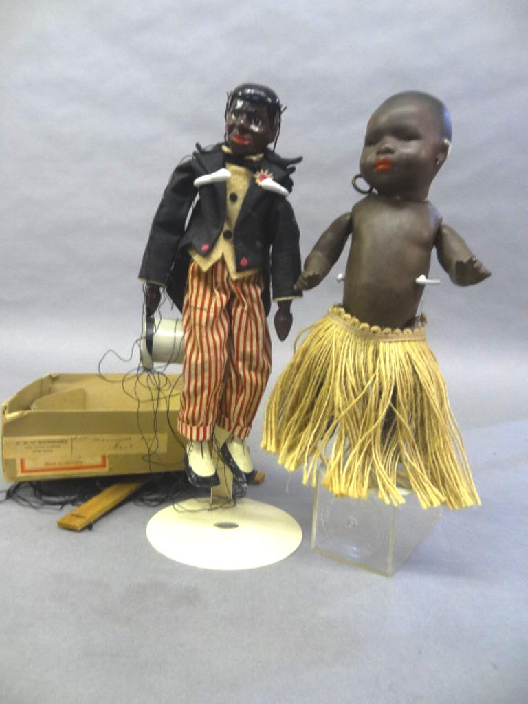 Heubach Koppelsdorf Black Doll & Puppet: Antique Heubach Koppelsdorf black child, solid dome bisque head with sleep eyes and closed mouth marked 399 . 13/0, 9"H, dressed in grass skirt and underwear, black minstrel doll with painted wood hea