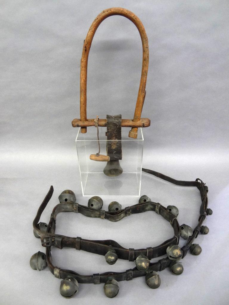 Graduated Strap Of Sleigh Bells & Cow Yoke: Antique leather mounted set of 18 graduated brass sleigh bells 1.5"D to 2.75"D, strap measures 74" between buckles, strap measures 93.5"L overall, antique European cow yoke wooden yoke with brass bell