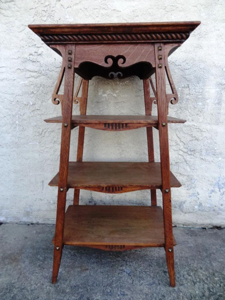 Arts & Crafts Oak Stand: Early Arts & Crafts Period oak stand, rectangular top with rope carved skirt, front and back legs have small brass pyramid decorations, three shelves, 18"W, 34"H, 16"D