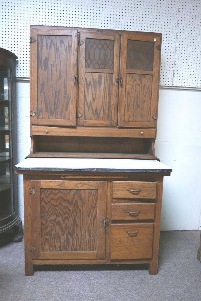Boone Hoosier Cabinet: Antique oak Hoosier cabinet, labeled Boone for the Boone County location of manufacturer Campbell-Smith-Ritchie, two doors have frost glass panels in a geometric pattern, slide out enamel covered coun
