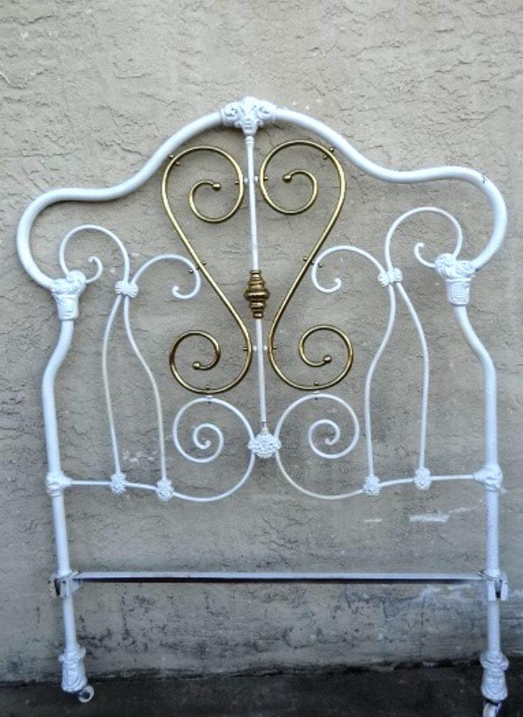 Antique Iron & Brass Full Bed: Antique full sized bed, white painted cast iron with brass trim, 48"W, headboard 66"H, footboard 48.5"H With Ladies Heads on feet of Bed