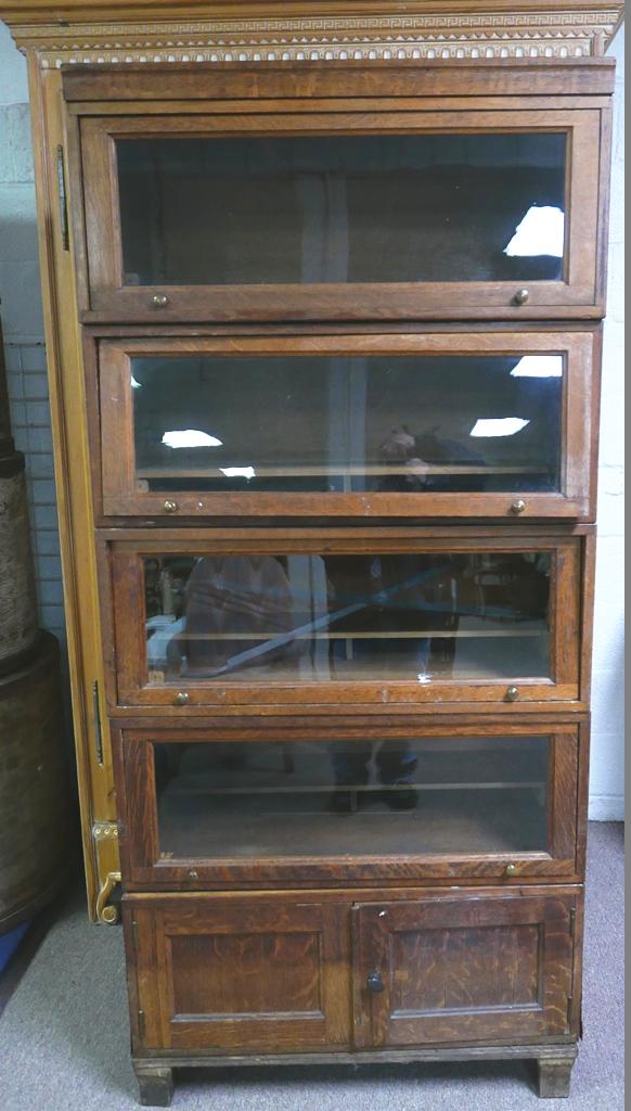 Antique Oak Barrister Bookcase, 5 Section: Antique oak barrister bookcase includes four sections with a sliding glass door and a base section with double doors, 33"W, 71.75"H, 17"D
