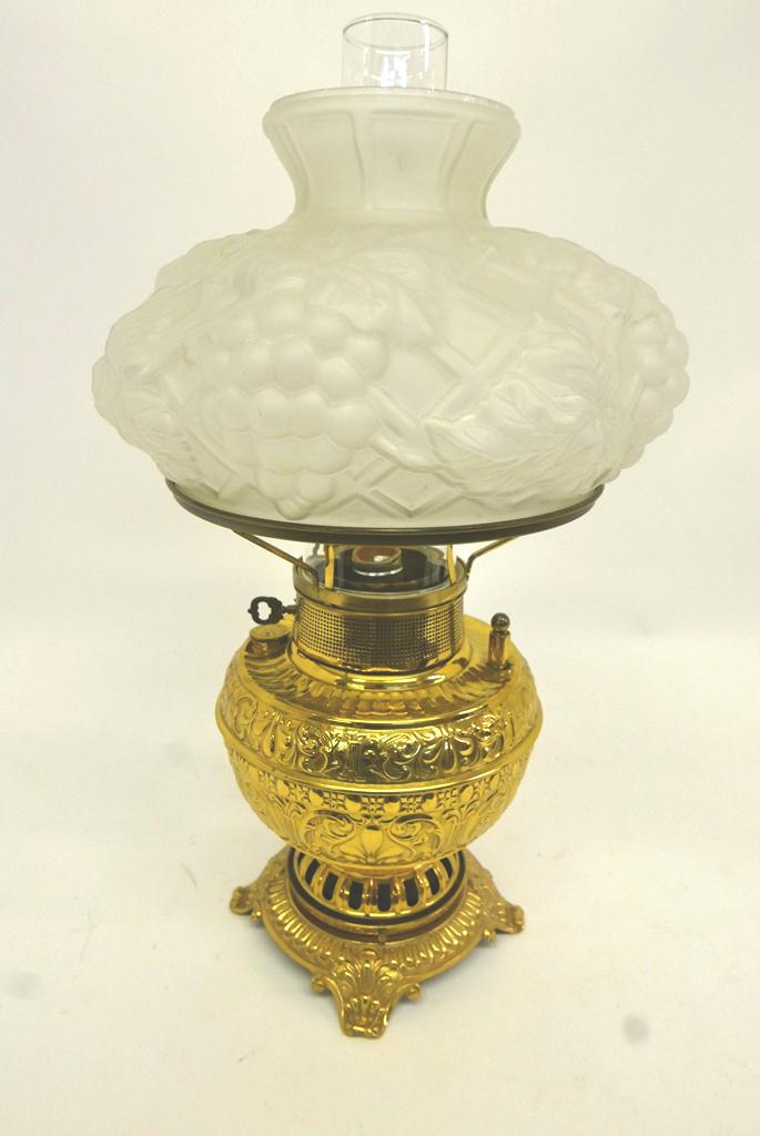Ornate Brass Parlor Lamp: Antique brass parlor lamp, polished brass repousse body, ornate cast fruit form frosted glass shade, clear globe, converted to electricity, 23"H