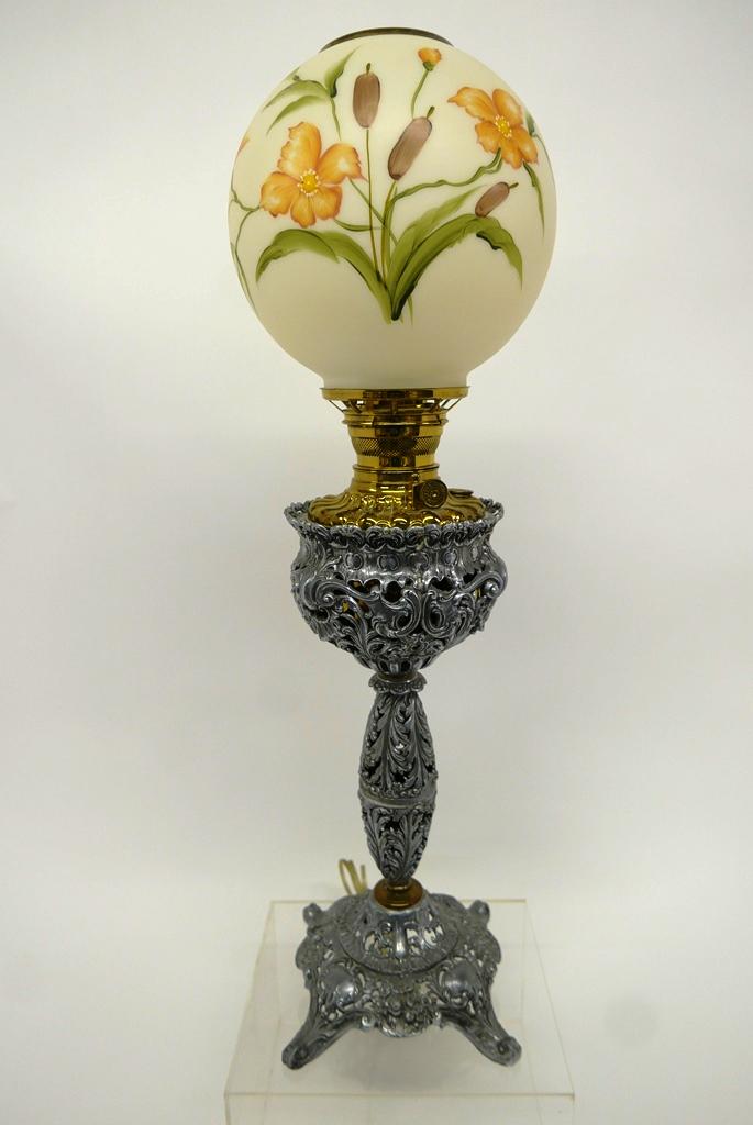 Ornate Antique Parlor Lamp: Ornate rococo style parlor lamp with cast metal base, brass reservoir and burner converted to electricity, hand painted floral globe, 28.75"H
