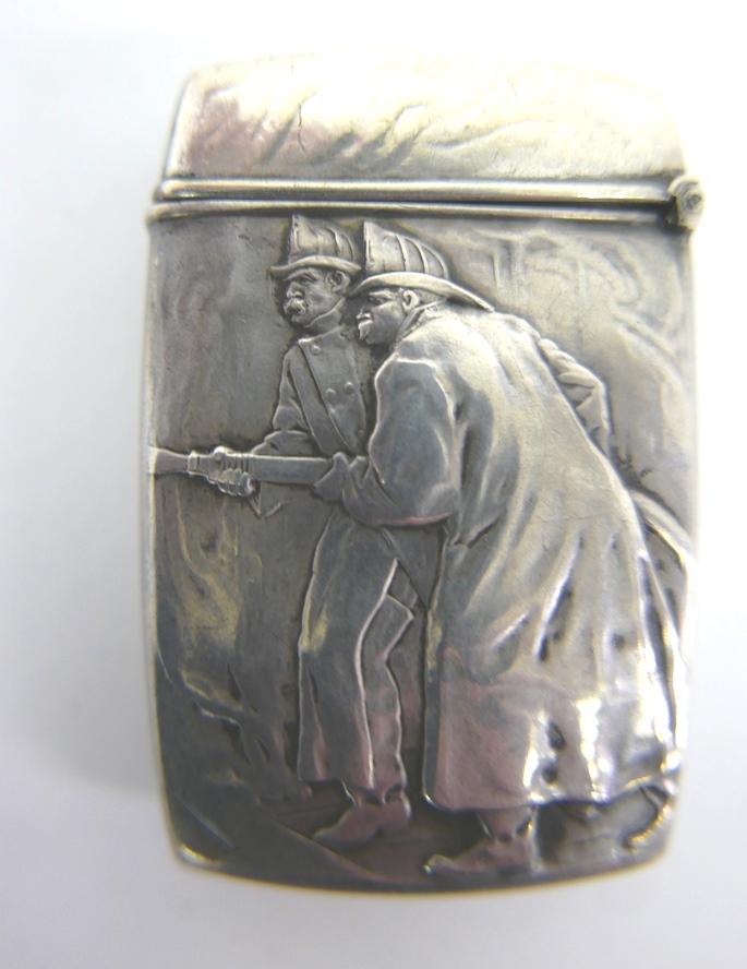 Sterling Fireman Advertising Match Safe: Antique sterling vesta case by the William B. Kerr & Co New York, depicts two fireman holding a hose and advertising for "The Home Insurance Company New York, striker on bottom 2.5"H